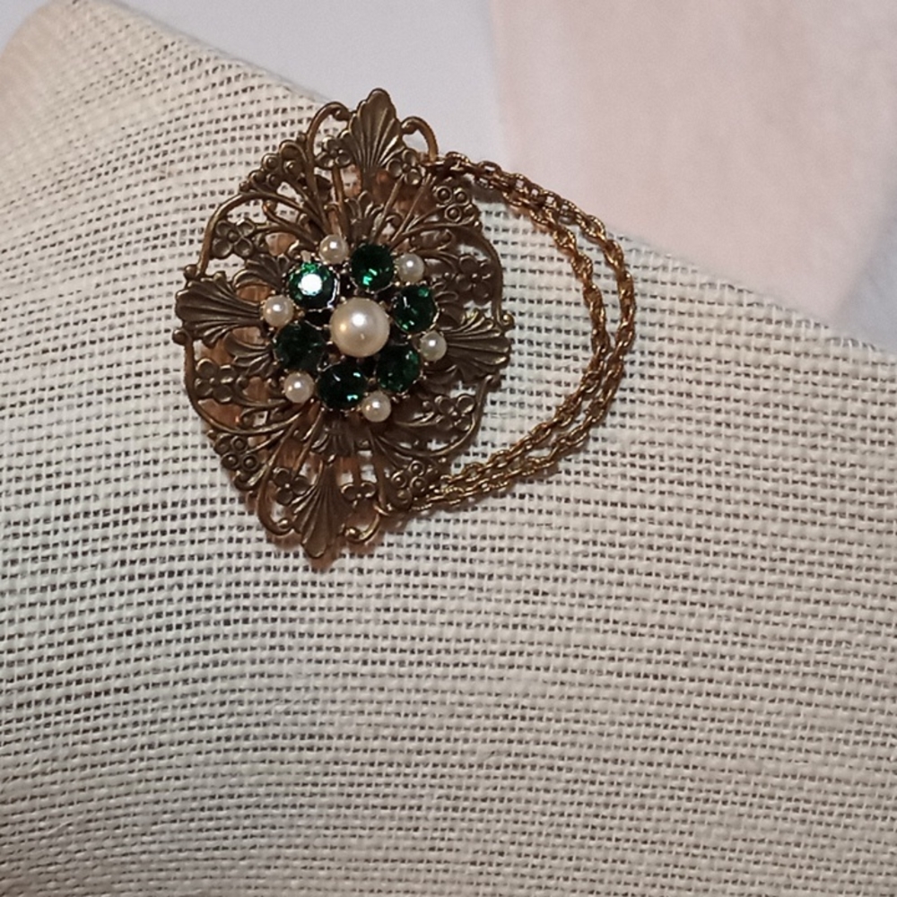Vintage brooch. Gold toned. Green rhinestones and faux perals.